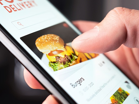 Someone using an online food delivery app on a smartphone